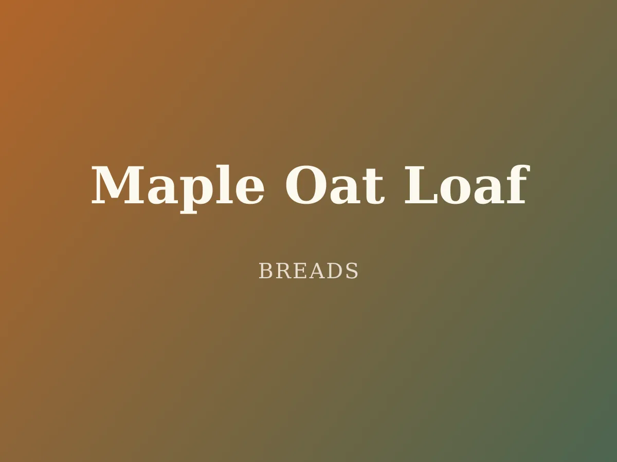 Maple Oat Loaf — a loaf of golden sandwich bread crowned with toasted oats