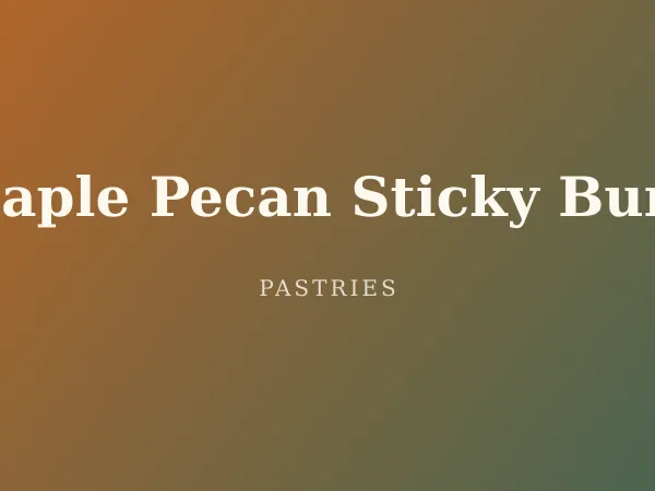 Maple Pecan Sticky Buns — close-up of one bun pulled apart, showing the cinnamon swirl